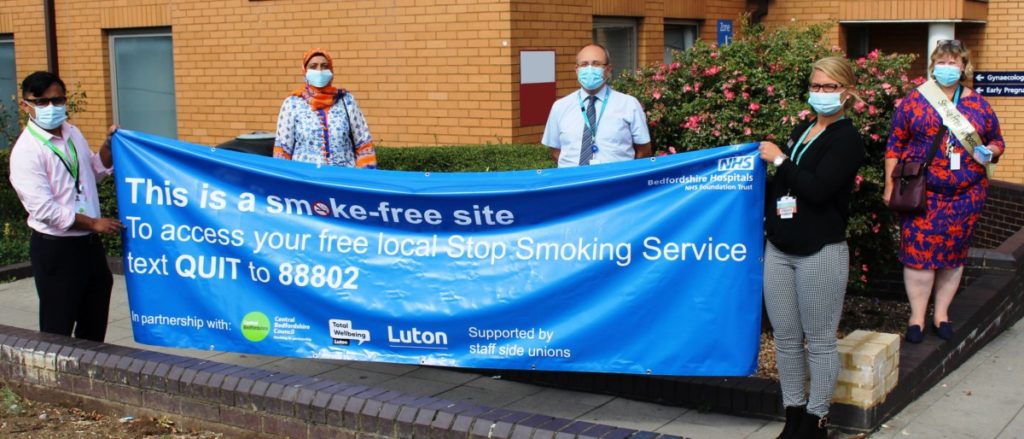Picture of Staff holding Smoke free banner