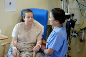 A nurse speaking to a patient