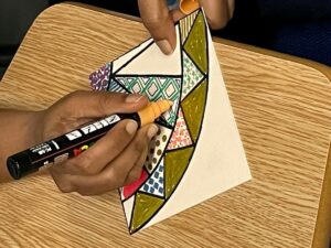 A person drawing some art on a piece of paper