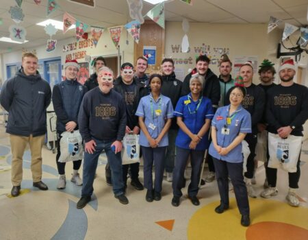 Staff receiving presents from Bedford Blues