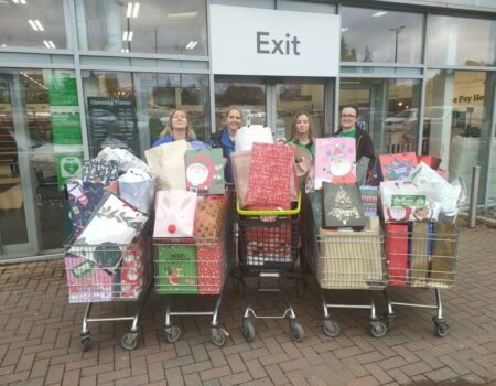 Staff with trolleys full of presents