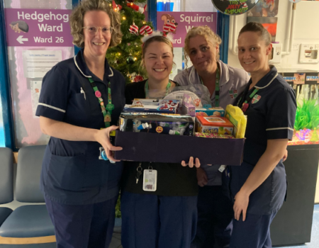 Staff with a hamper of presents