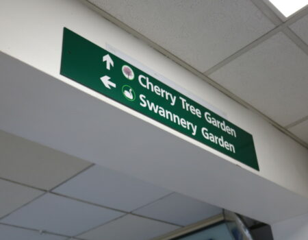 Green hospital signage directing to Swannery Garden