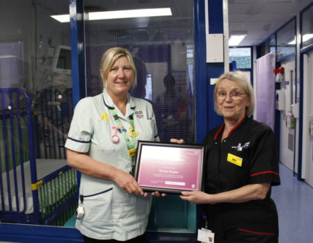 Shirley receiving her certificate from Bill