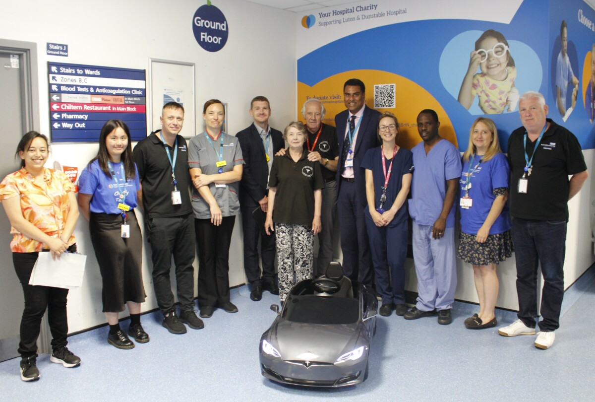 Peter Smoothly and his wife from Tesla Owners Club alongside staff from theatres, paediatrics and Bedfordshire Hospitals NHS Charity