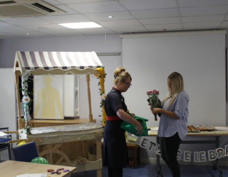 Victoria receiving flowers from Liz