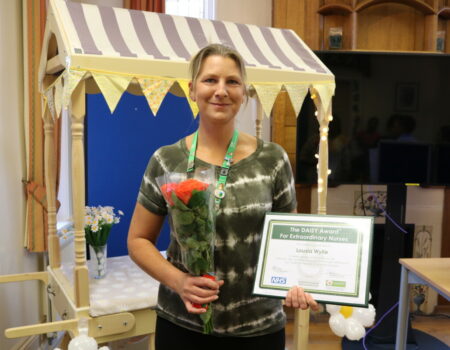 Louisa with her certificate and flowers