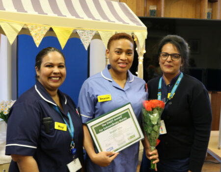 Sharon holding her certificate with Magi and Shilby