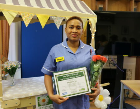 Sharon with her certificate and flowers