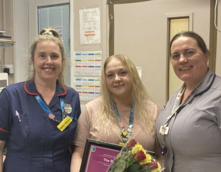 Lisa Smith holding her ROSE runner-up certificate with Abbie and Tanya