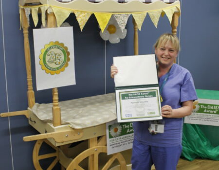 Pam with her certificate and the DAISY cart