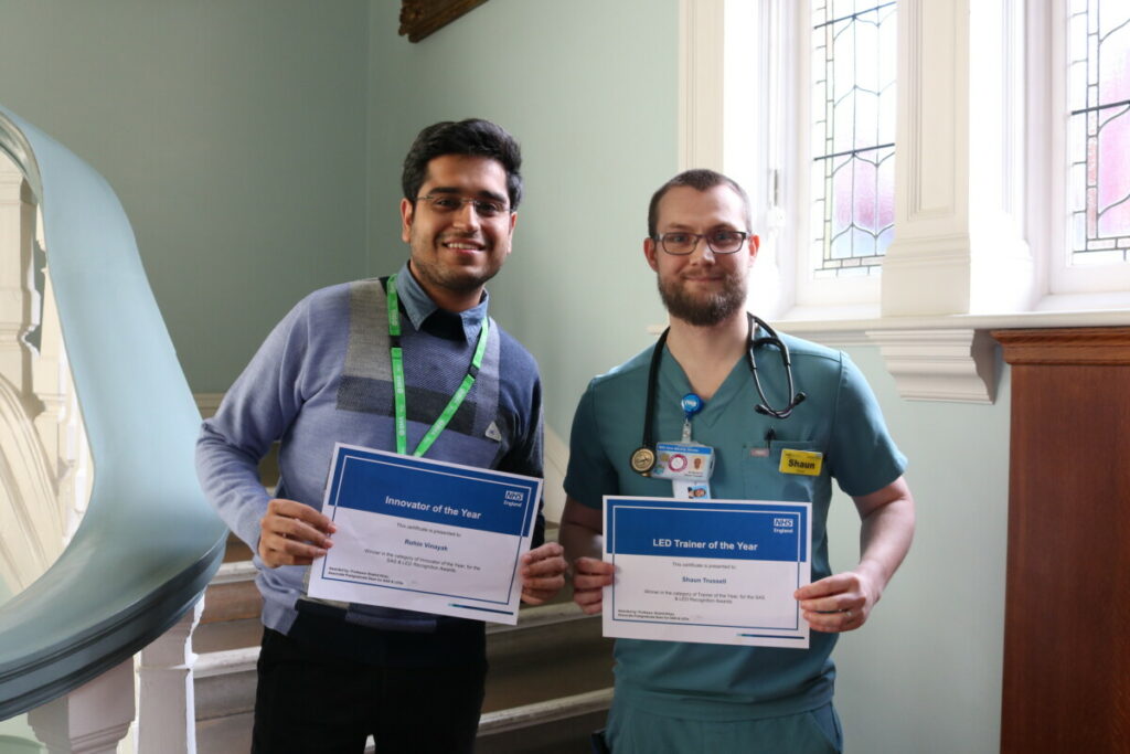 Dr Rohin Vinayak and Dr Shaun Trussell holding their certificates